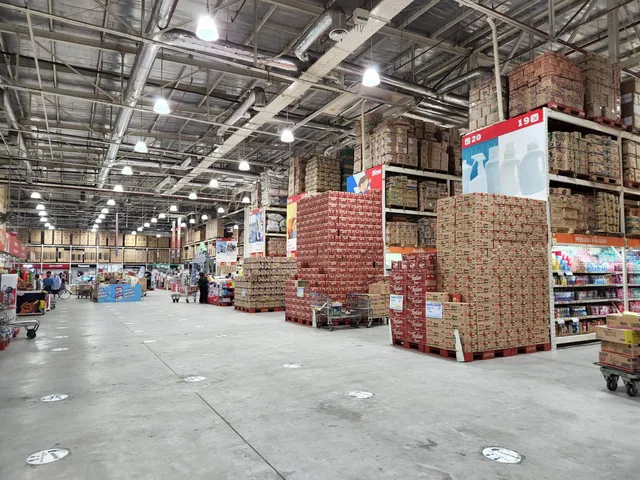 A large wholesale warehouse interior filled with stacked merchandise and shoppers browsing the aisles. B2B ecommerce SEO: how to optimise wholesale and trade stores
