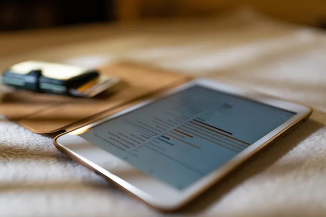 Close-up of a tablet displaying financial graphs on a soft white surface, ideal for business concepts. Building ecommerce SEO buyer personas without invented customer detail