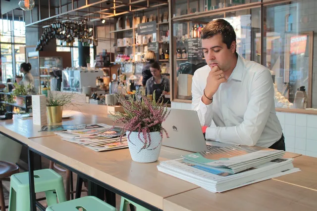 businessman, laptop, online, man, male, thinking, cafe. Check the ecommerce SEO market size in England before you budget
